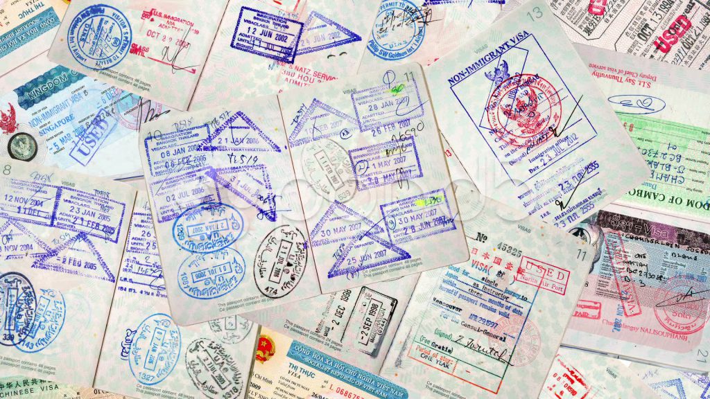 A pile of passports with visa stamps.